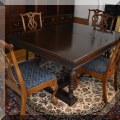 F09. Walnut Jacobean style dining table with leaves. 30"h x 63"w x 48"d (includes pads) 